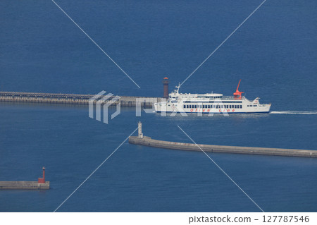 The ferry, Shodoshima Maru, enters Takamatsu Port, passing by the Tamamo breakwater and the red lighthouse. The ferry, Shodoshima Maru, enters Takamatsu Port, passing by the Tamamo breakwater and the red lighthouse. 127787546