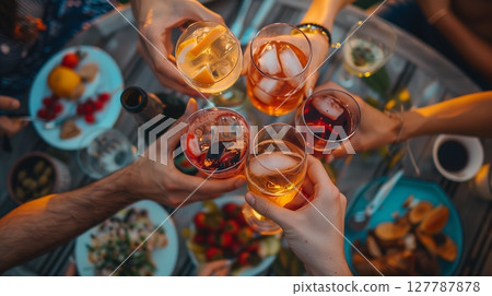 Overhead shot of friends toasting at a lively rooftop party, capturing friendship and celebration. 127787878