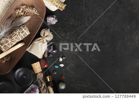 Mystical Flat Lay of Sage, Crystals, and Dried Herbs on Dark Surface 127788449