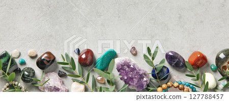 Border of Healing Crystals and Greenery on Concrete Surface 127788457