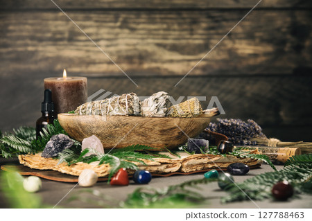 Aromatic Sage Bundles with Healing Crystals on Wooden Table Aromatic Sage Bundles with Healing Crystals on Wooden Table 127788463