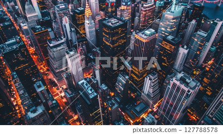 Aerial shot of a bustling cityscape at dusk: skyscrapers, shadows, vibrant city lights, dynamic urban energy. 127788578