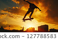 A low-angle shot captures a skateboarder mid-air at sunset, vividly highlighting the thrill and energy. 127788583