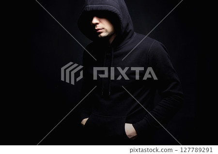 Person in Hood. Man or Boy in a hooded sweatshirt 127789291