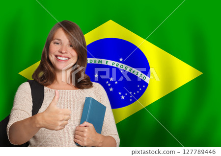 Smiling woman student against Brazilian flag background. Travel, education  127789446