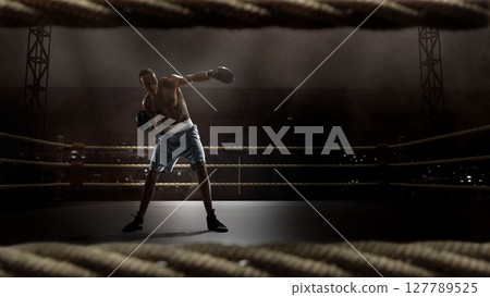 Tattooed boxer in defense pose on 3D boxing ring. Boxing event campaigns 127789525