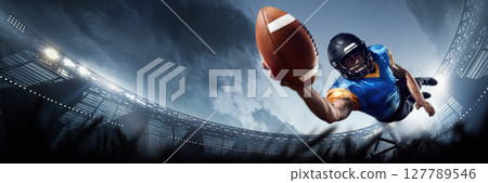 Touchdown leap, football player stretches arm with ball in 3D game arena. Sports marketing 127789546