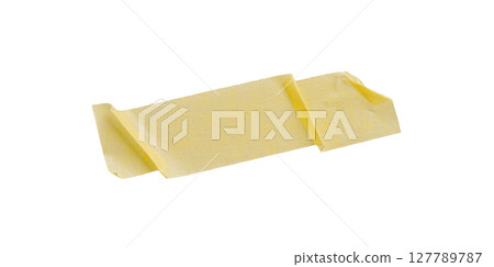 Yellow painter's tape isolated on white background, macro. Torn, crumpled, twisted strips of yellow painter's tape on white background 127789787