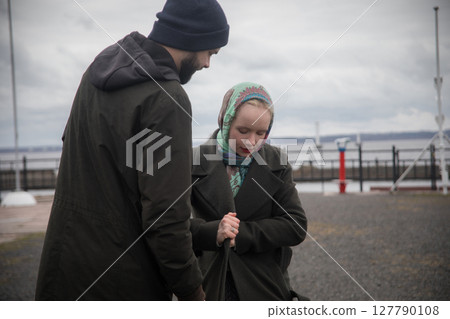 Cute woman and man walking in the park. Beautiful young couple outdoors portrait Cute woman and man walking in the park. Beautiful young couple outdoors portrait 127790108