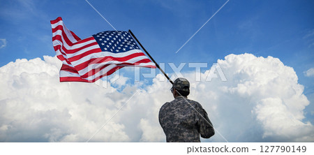 back side of soldier in military uniforms is standing waving a America flag under blue sky in celebration of the nation holiday for 4th of July, Memorial Day, Independence Day and celebrate victory back side of soldier in military uniforms is standing waving a America flag under blue sky in celebration of the nation holiday for 4th of July, Memorial Day, Independence Day and celebrate victory 127790149