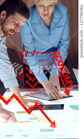 Business professionals analyze data amid economic downturn warning. Digital economy crash Business professionals analyze data amid economic downturn warning. Digital economy crash 127790362