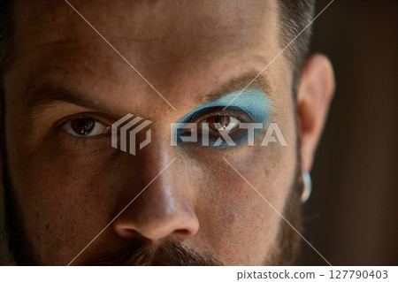 Dopamine split. Man with one side in full Y2K color, the other left bare. Split-makeup contrast. 127790403