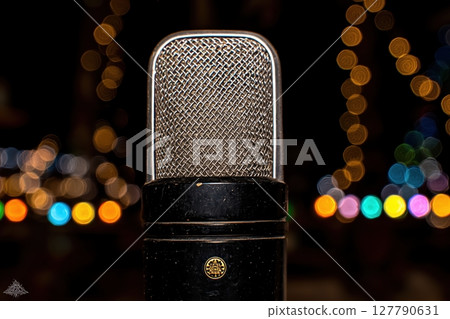 Classic retro microphone on blurred background. 127790631