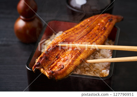 A whole grilled eel on rice A whole grilled eel on rice 127790951