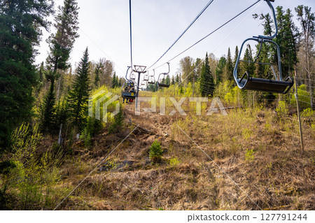 A ski lift to Mount Kokuya at the Teletskoye ski resort. A ski cable car carries tourists in Altai, Russia. A ski lift to Mount Kokuya at the Teletskoye ski resort. A ski cable car carries tourists in Altai, Russia. 127791244