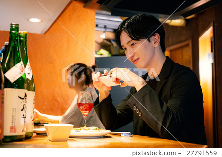 Man drinking at a bar 127791559