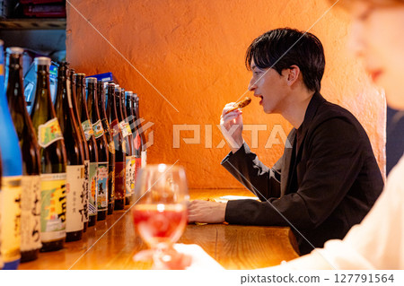 Man drinking at a bar 127791564