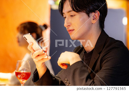 Man drinking at a bar 127791565