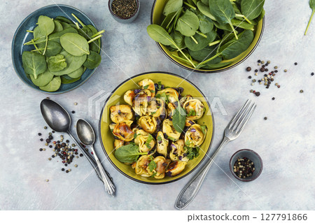 A plate of ravioli filled with a green spinach. A plate of ravioli filled with a green spinach. 127791866