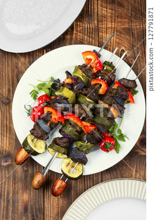 Metal skewers with delicious roe meat. 127791871