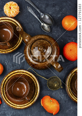 Glass kettle of tangerines tea. Glass kettle of tangerines tea. 127791883
