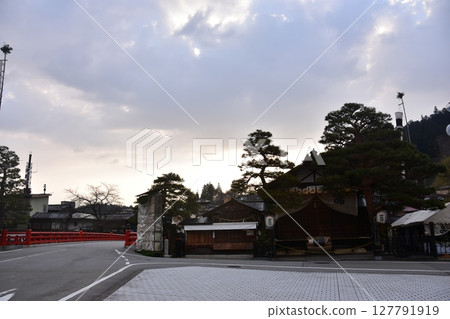 During the spring Takayama Festival in Gifu Prefecture, Japan, the tourist attraction Nakabashi Bridge, a beautiful sunrise and a shrine decorated with lanterns 127791919