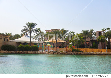 Architecture of the old district of Dubai in oriental style, near the water canal Architecture of the old district of Dubai in oriental style, near the water canal 127792273