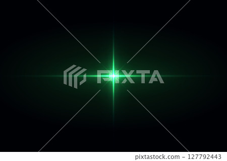 Glowing green starburst flare in black cosmic background 127792443