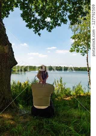 A Child and an Adult Enjoying Nature Together by the Beautiful Lake and Surroundings A Child and an Adult Enjoying Nature Together by the Beautiful Lake and Surroundings 127792509