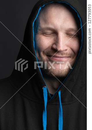 Happy man with hoodie sweatshirt close-up studio portrait 127793053