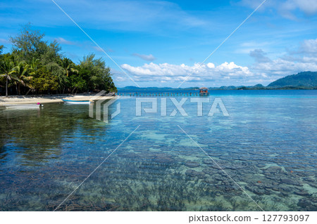 Wooden jetty and boat at Bolilanga Island, Togian archipelago, Sulawesi, Indonesia Wooden jetty and boat at Bolilanga Island, Togian archipelago, Sulawesi, Indonesia 127793097