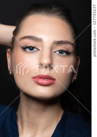 Beautiful woman with day make-up close-up studio portrait 127793237