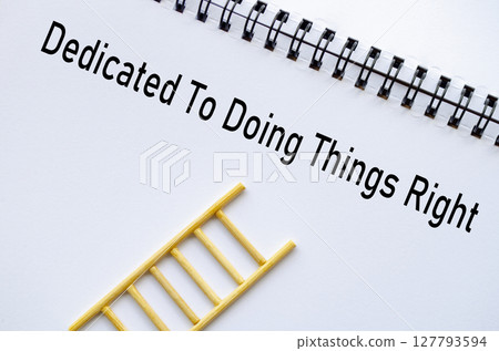 Dedicated To Doing Things Right on notebook with ladder symbolizing ethics and values 127793594
