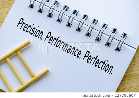 Precision At Its Best written on spiral notebook with ladder representing focus and accuracy Precision At Its Best written on spiral notebook with ladder representing focus and accuracy 127793607