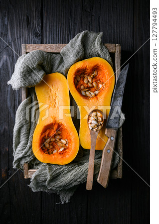Halved raw butternut squash with seeds 127794493