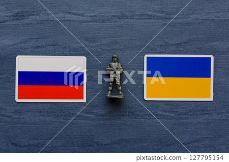 Flags of Russia and Ukraine on a blue background. The Russian-Ukrainian conflict. Flags of Russia and Ukraine on a blue background. The Russian-Ukrainian conflict. 127795154