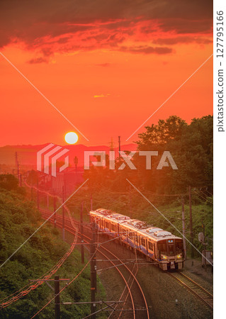 Traveling along the railway line bathed in the setting sun Traveling along the railway line bathed in the setting sun 127795166