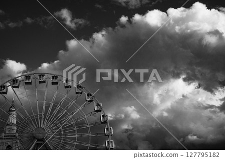 Dramatic Ferris Wheel Against Stormy Sky in Black and White Dramatic Ferris Wheel Against Stormy Sky in Black and White 127795182