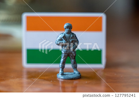 A tin soldier on the background of the Indian flag. India Pakistan military conflict A tin soldier on the background of the Indian flag. India Pakistan military conflict 127795241