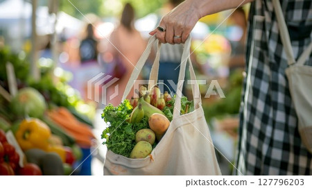 Fresh greens in eco bag at market with veggies. Perfect for sustainable living or healthy lifestyle posts. Adds natural, vibrant touch to food blogs. 127796203