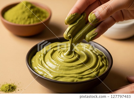 Artisan Hands Creating Luxurious Matcha Green Tea Skincare Mask in Ceramic Bowl Artisan Hands Creating Luxurious Matcha Green Tea Skincare Mask in Ceramic Bowl 127797483