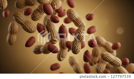 Dynamic cascade of roasted peanuts and shells floating against warm golden backdrop Dynamic cascade of roasted peanuts and shells floating against warm golden backdrop 127797539