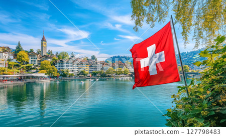 Swiss flag waving in the wind during a sunset celebration of independence and national pride Swiss flag waving in the wind during a sunset celebration of independence and national pride 127798483
