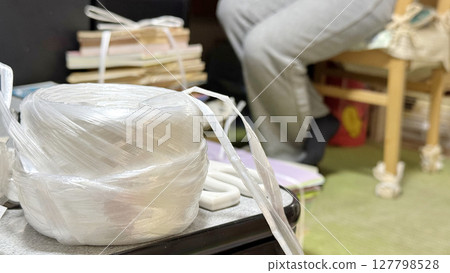 The feet of a person behind the plastic rope The feet of a person behind the plastic rope 127798528