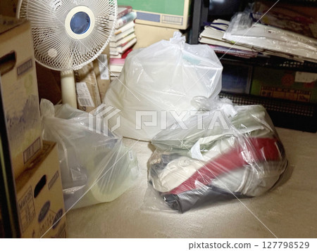 A fan or a garbage bag in a dark room A fan or a garbage bag in a dark room 127798529