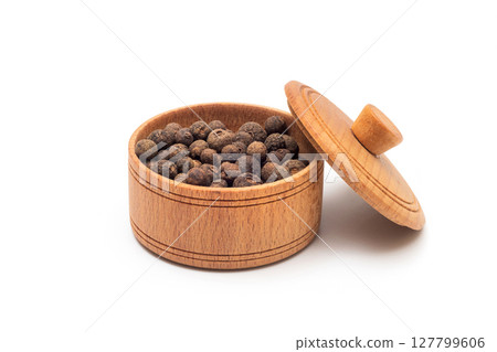 Black pepper in wooden bowl isolated on white Black pepper in wooden bowl isolated on white 127799606