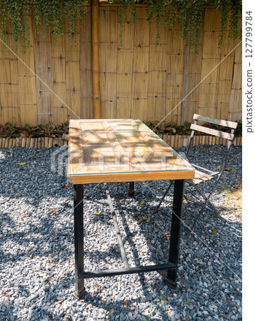 Rustic Wooden Table in Quaint Garden Cafe. 127799784