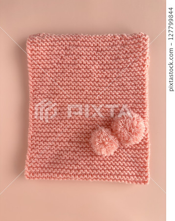 Soft pink lace knitted round scarf isolated on pastel pink background. Fashion children's accessory. 127799844