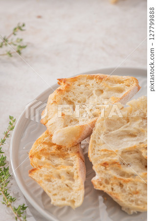 Grilled bread toasts on the plate with copy space 127799888