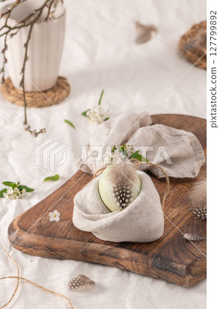 Stylish Easter brunch table setting with egg in easter bunny napkin. 127799892